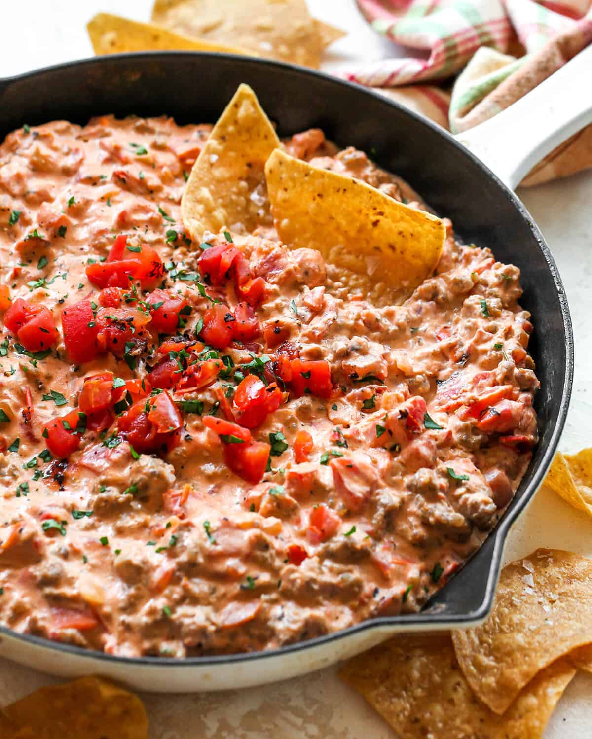 Cream Cheese Sausage Dip in a skillet with chips 