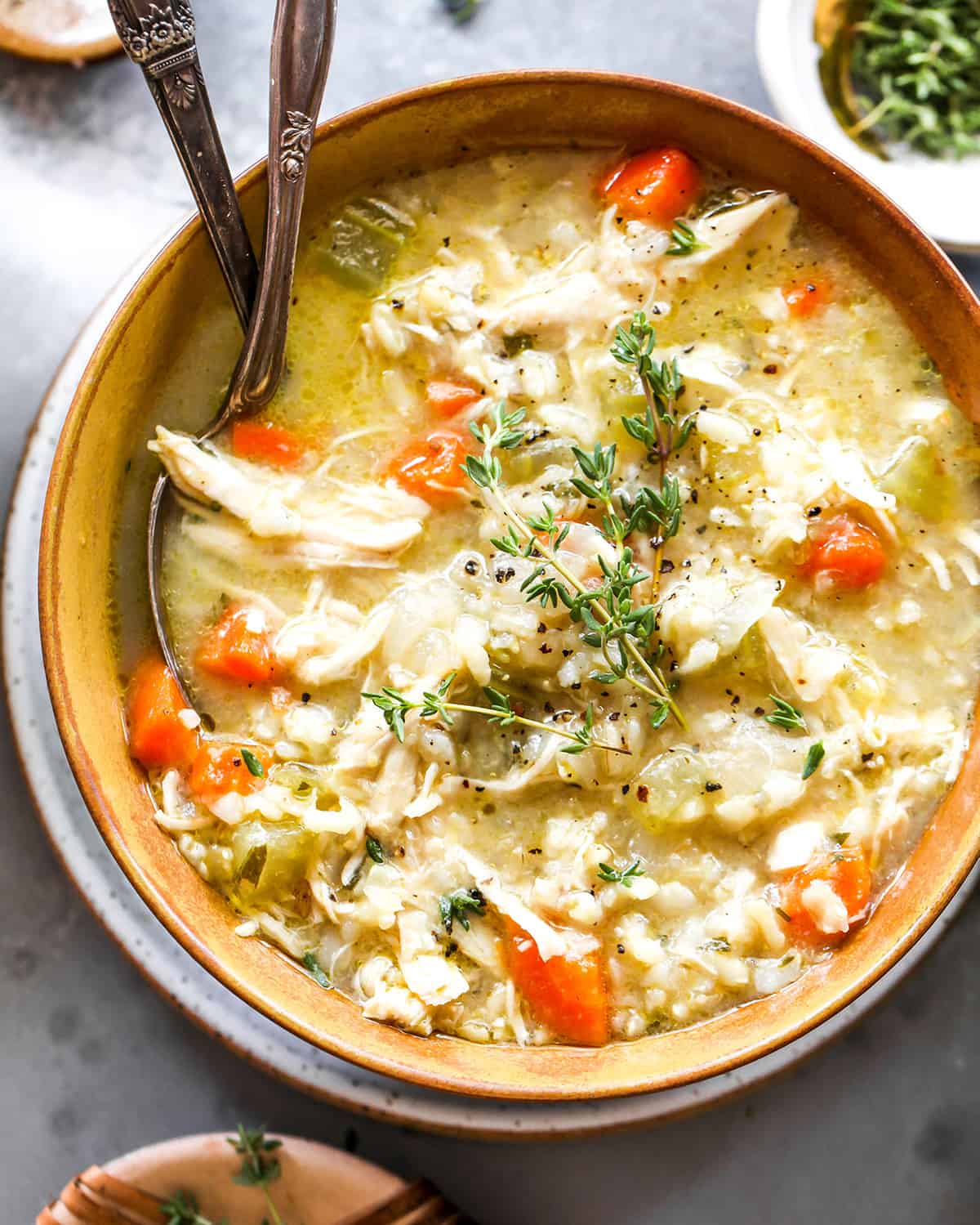 overhead photo of chicken and wild rice soup in a bowl with fresh herbs
