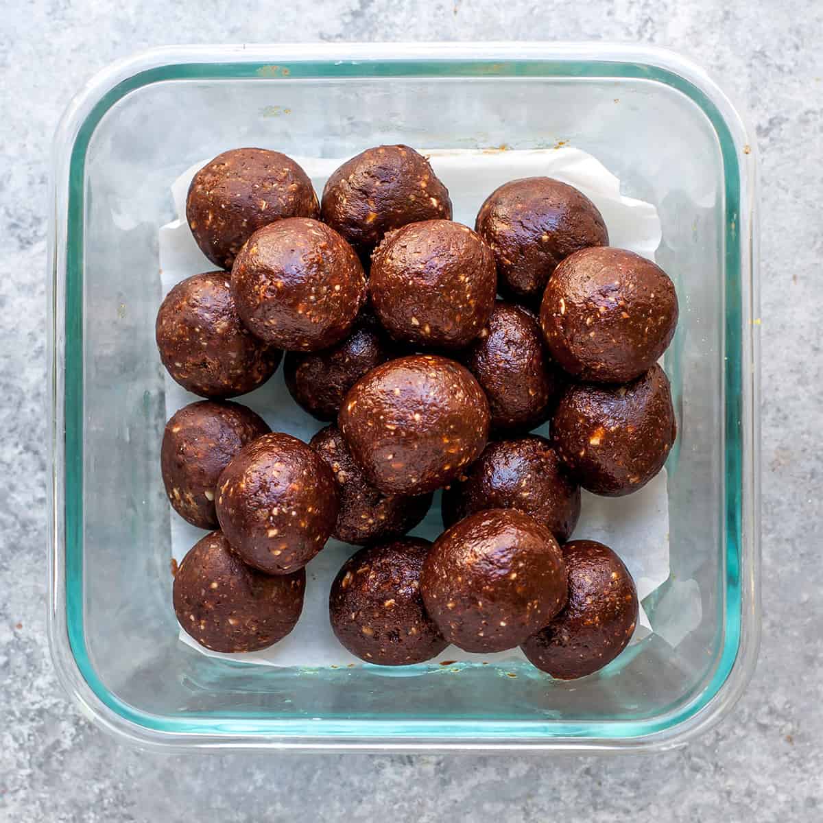 overhead view of date energy balls in a glass container 
