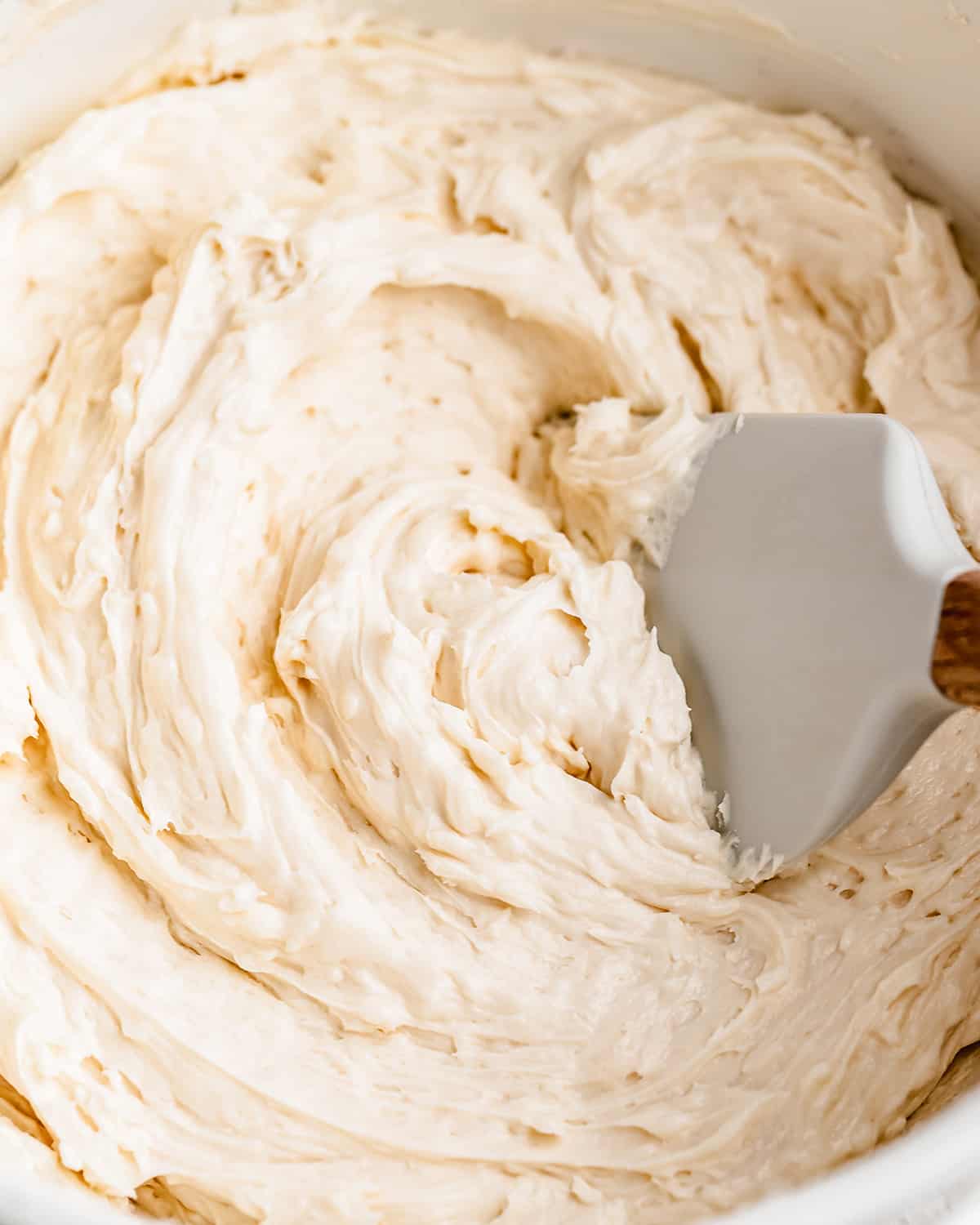 Coconut Frosting in a bowl with a spatula