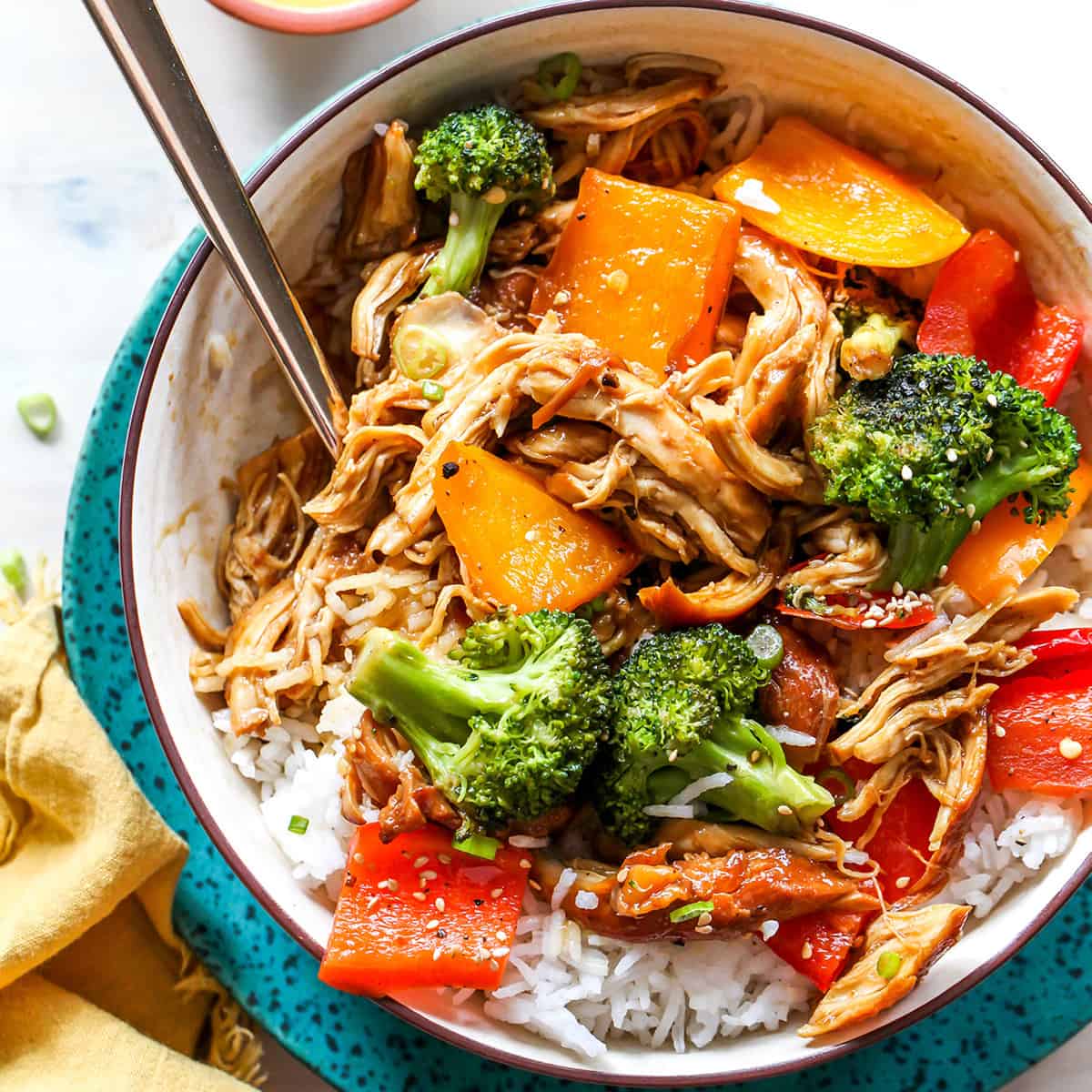 overhead view of a bowl of crockpot teriyaki chicken with veggies and rice
