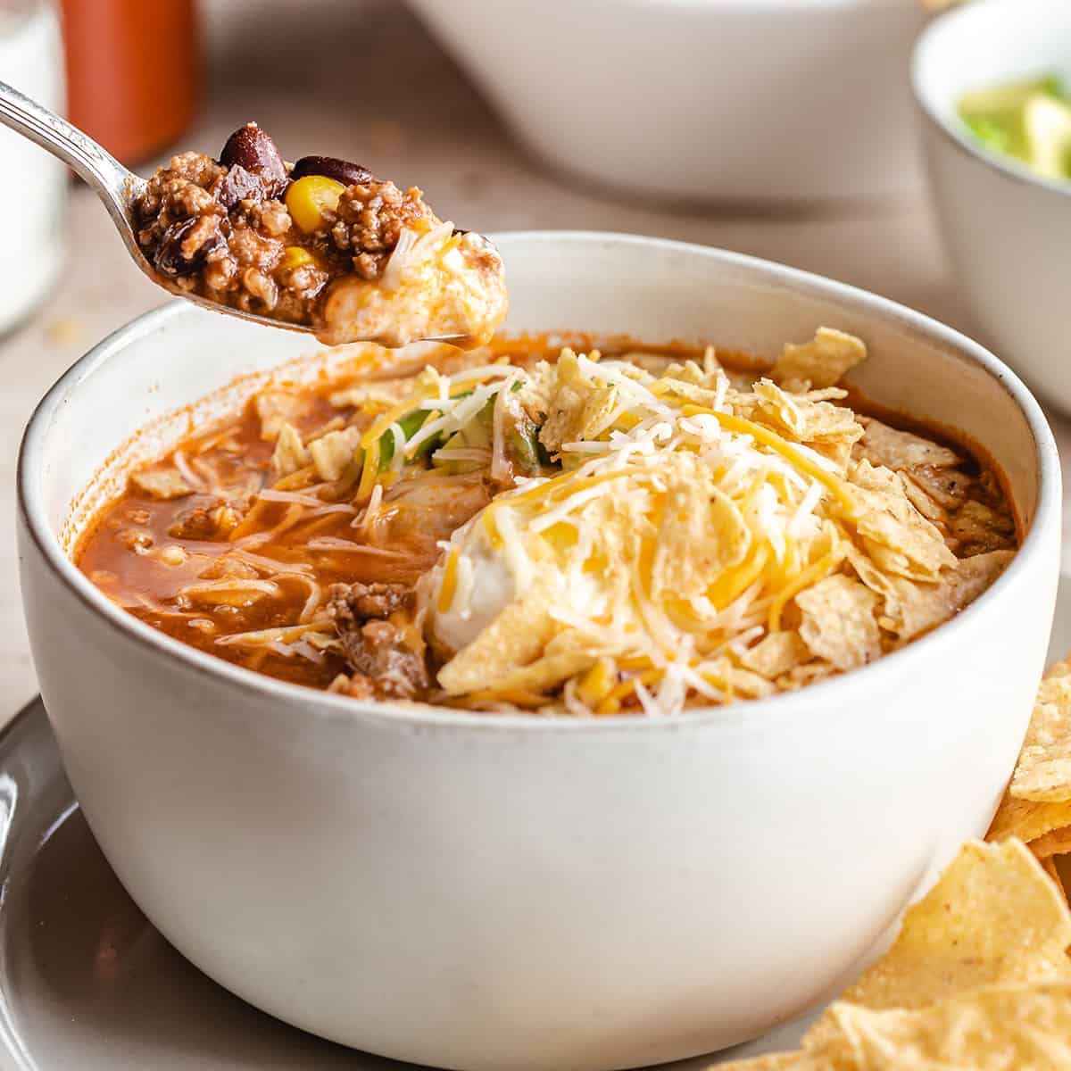 a spoon taking a scoop of Taco Soup out of a bowl