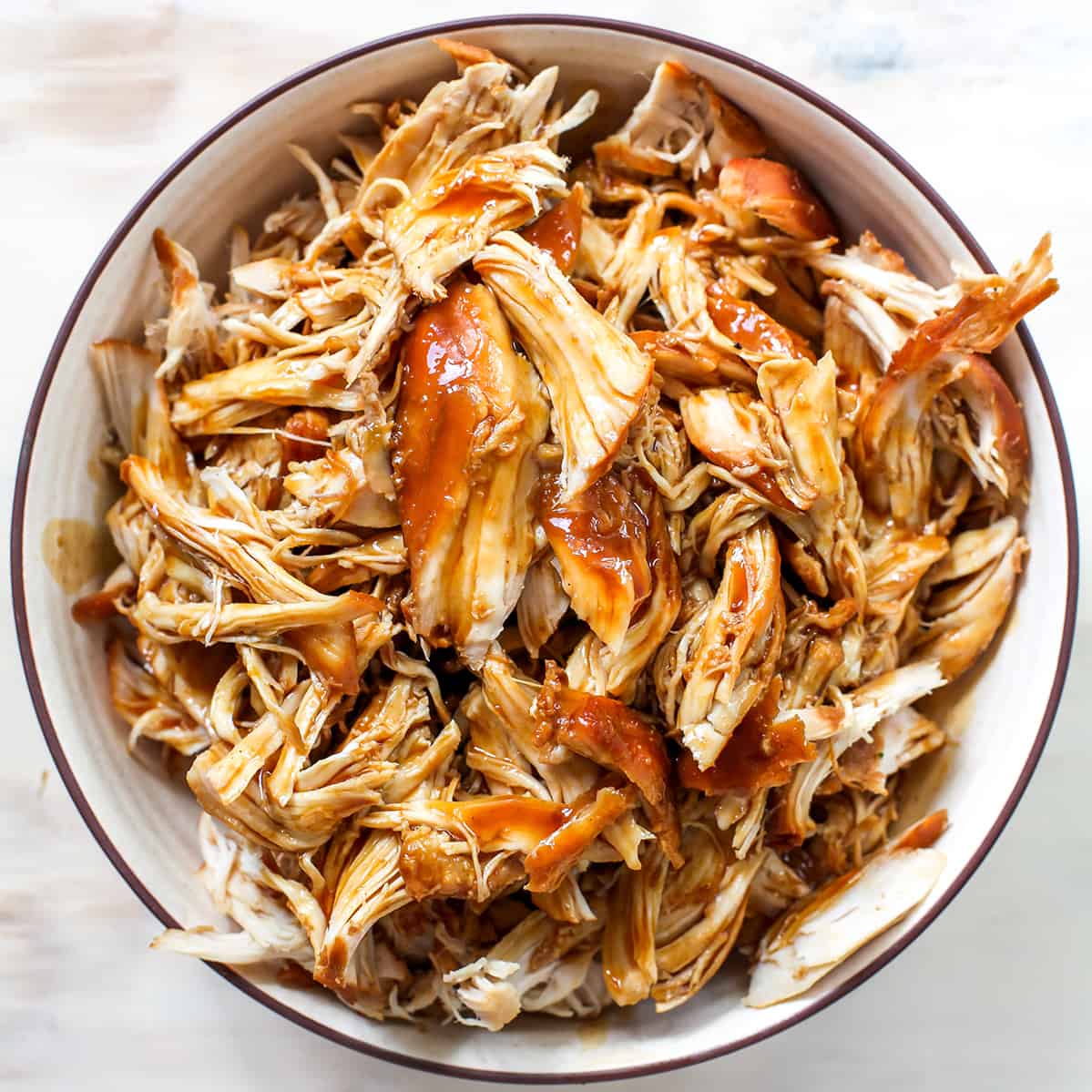 overhead photo of crockpot teriyaki chicken in a bowl