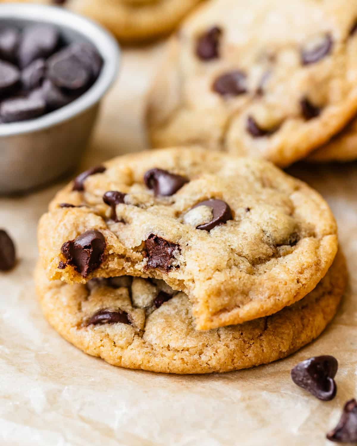 a stack of 2 Dairy Free Chocolate Chip Cookies, one with a bite taken out of it 