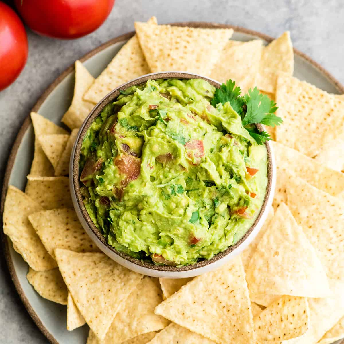 overhead view of a bowl of guacamole surrounded by chips