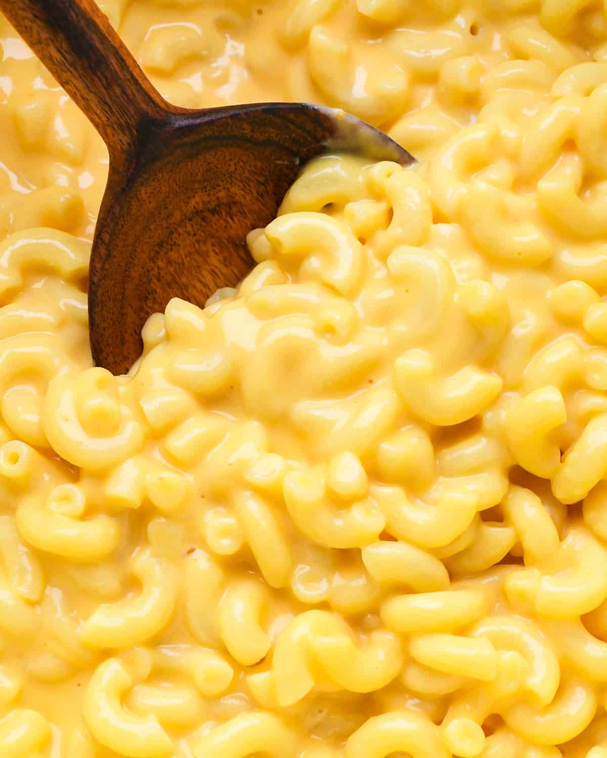 overhead view of Homemade Mac and Cheese in a pot with a spoon taking a scoop