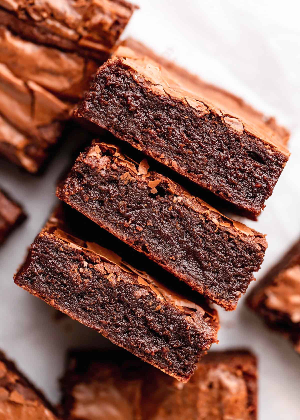 three brownies laying on their side so the fudgy inside is visible