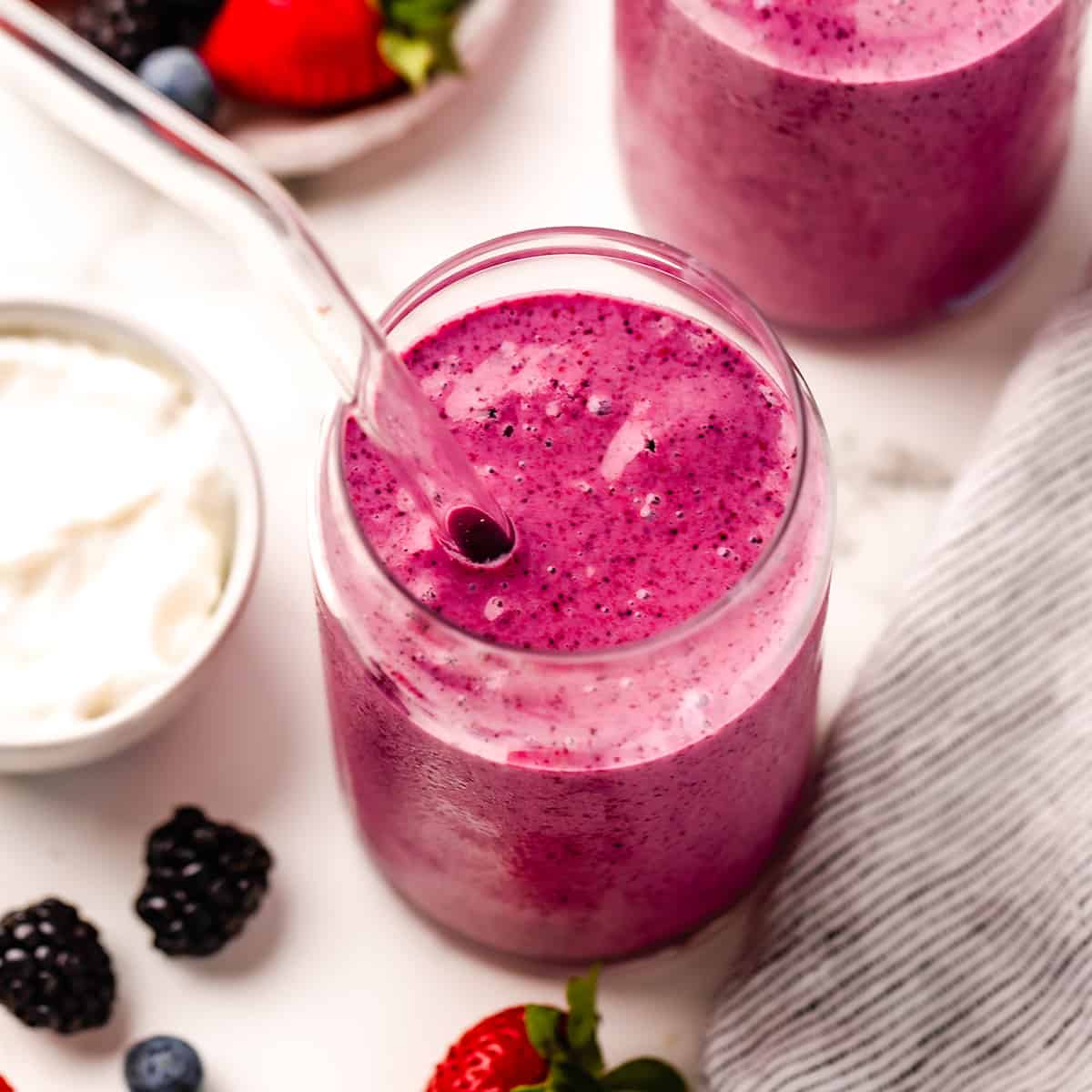 2 glasses with Greek Yogurt Smoothie inside. one with a straw