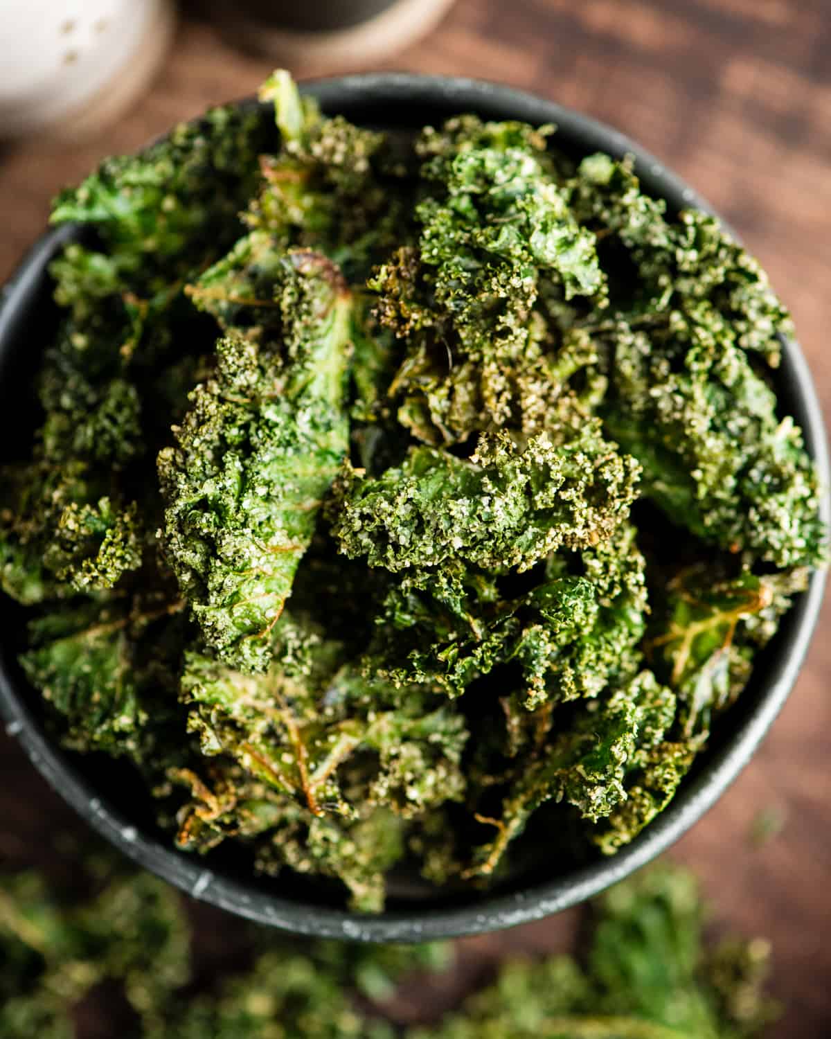 overhead view of baked kale chips in a bowl