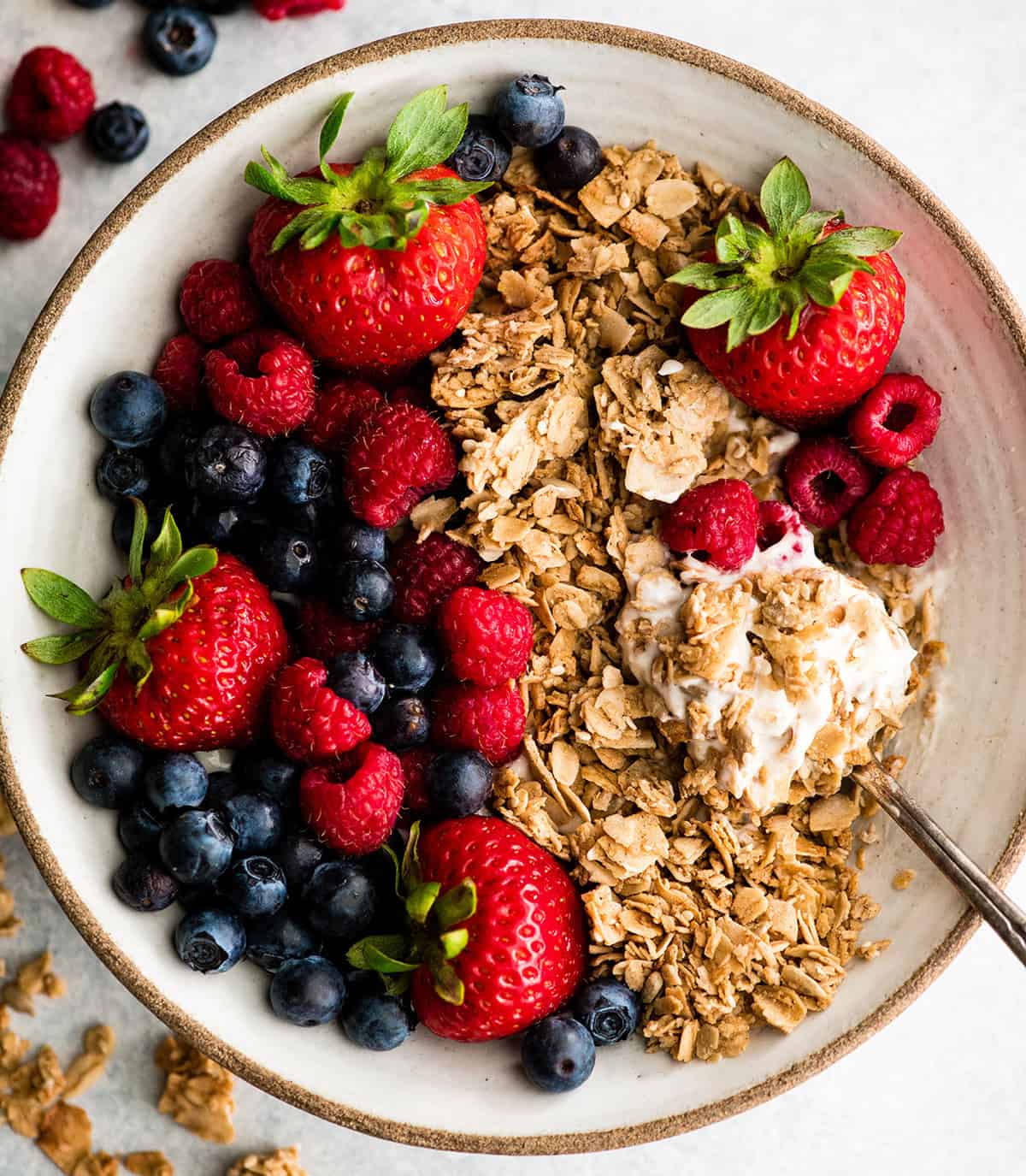overhead view of a spoon taking a bite of homemade granola