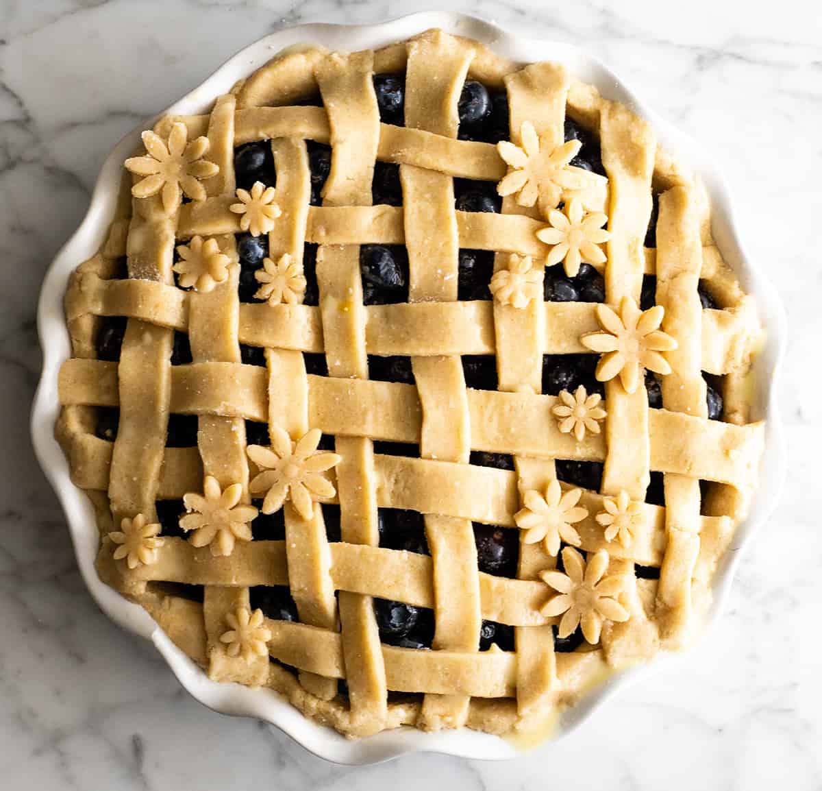 overhead view of a blueberry pie before baking