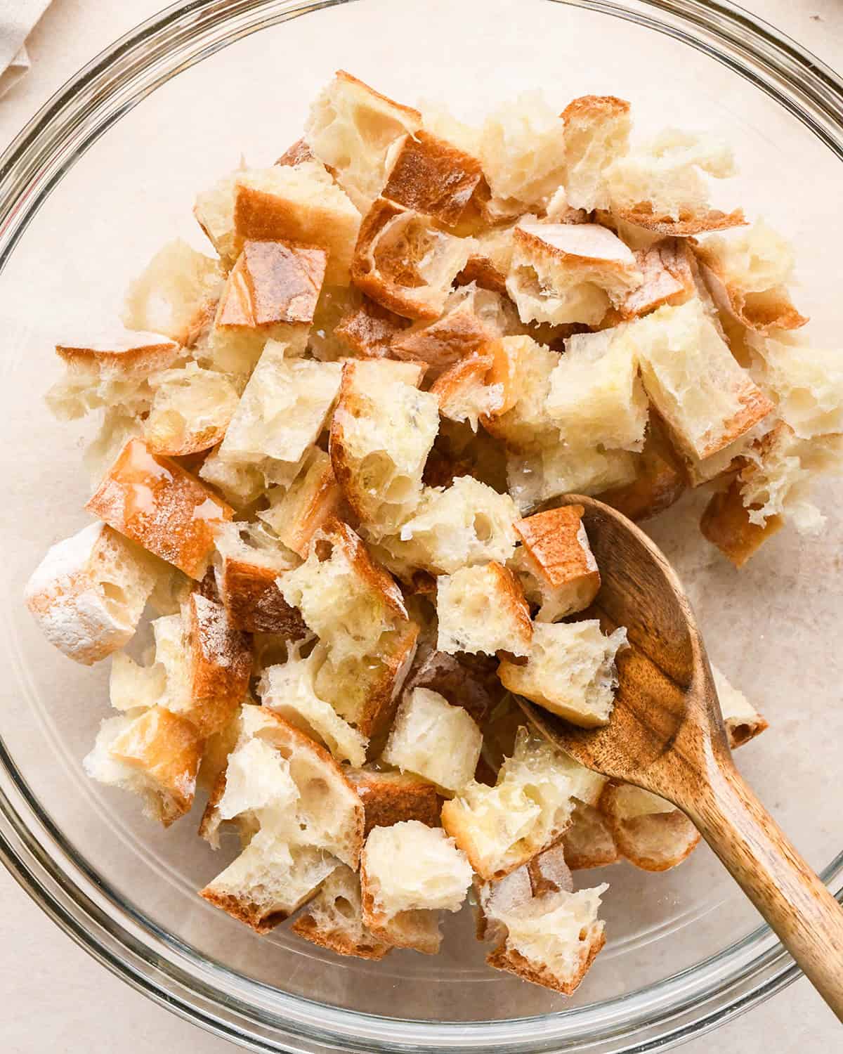 How to Make Croutons - stirring olive oil into bread cubes
