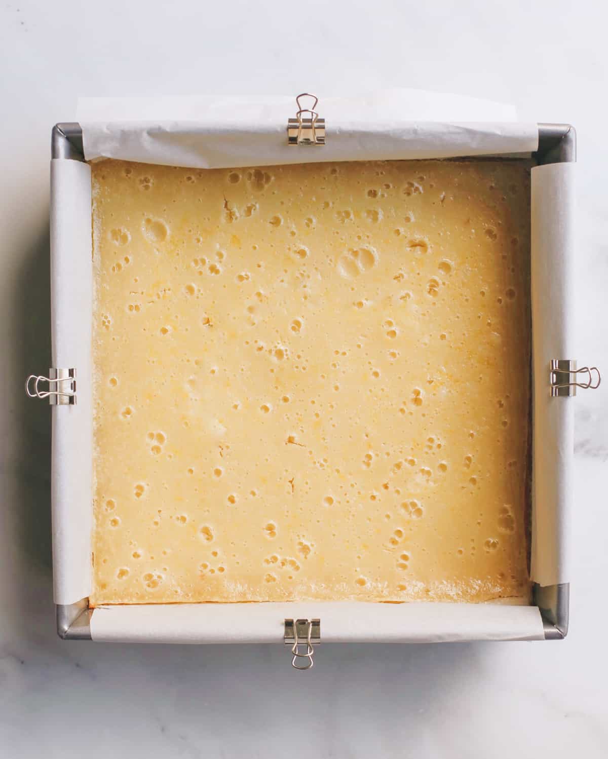 lemon bars after baking in a baking dish
