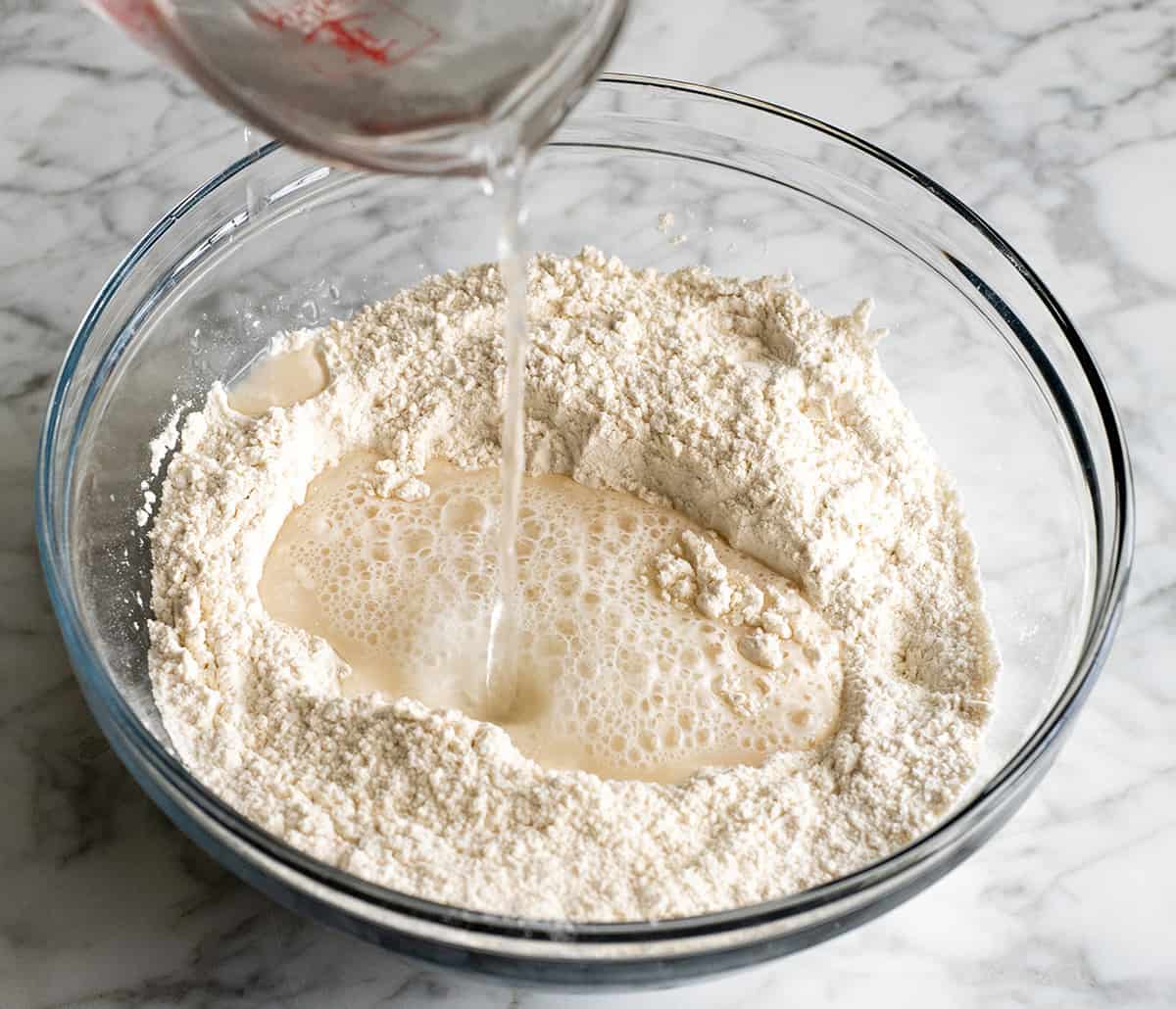 front view of water being added showing how to make no knead bread