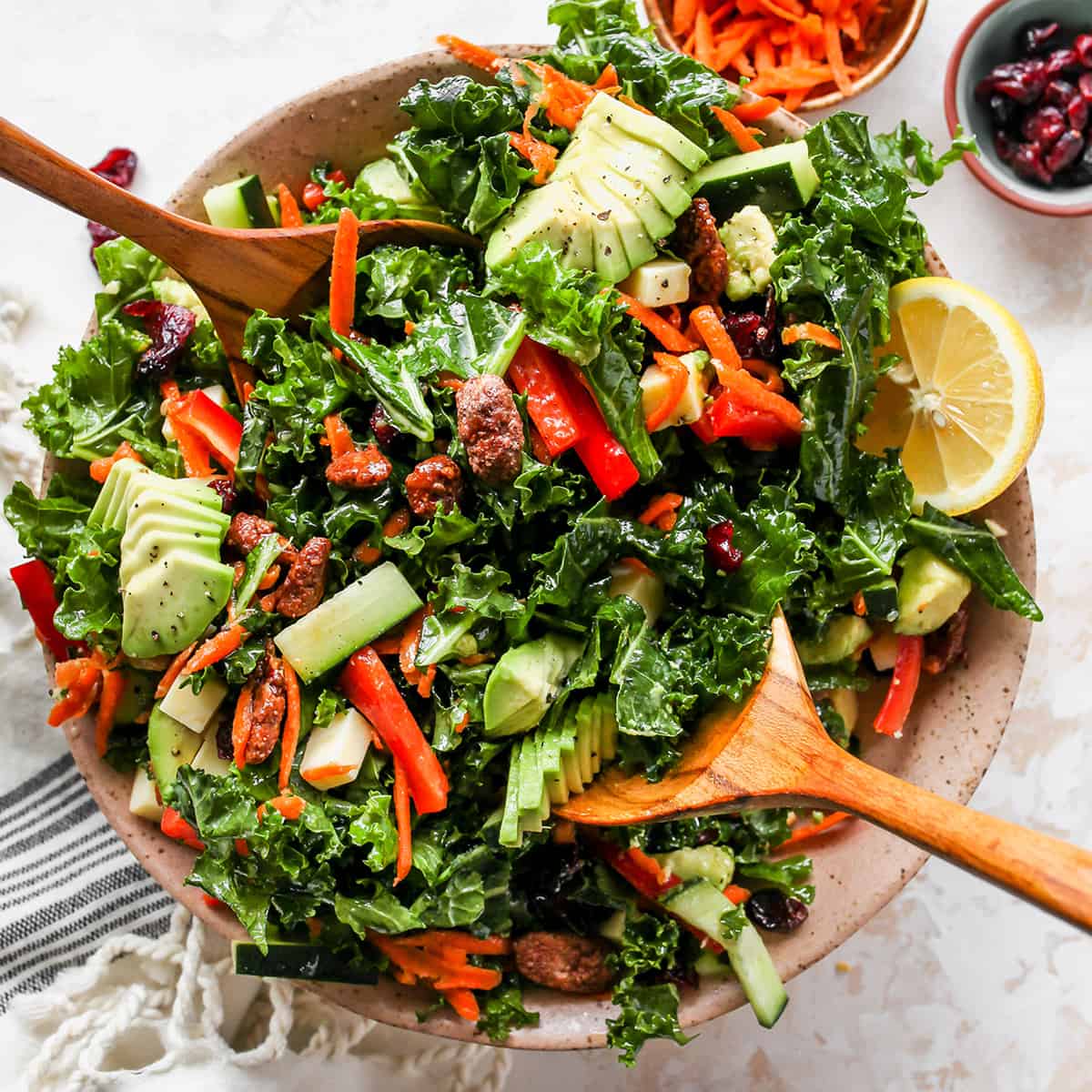 overhead photo of wood spoons serving Kale Salad