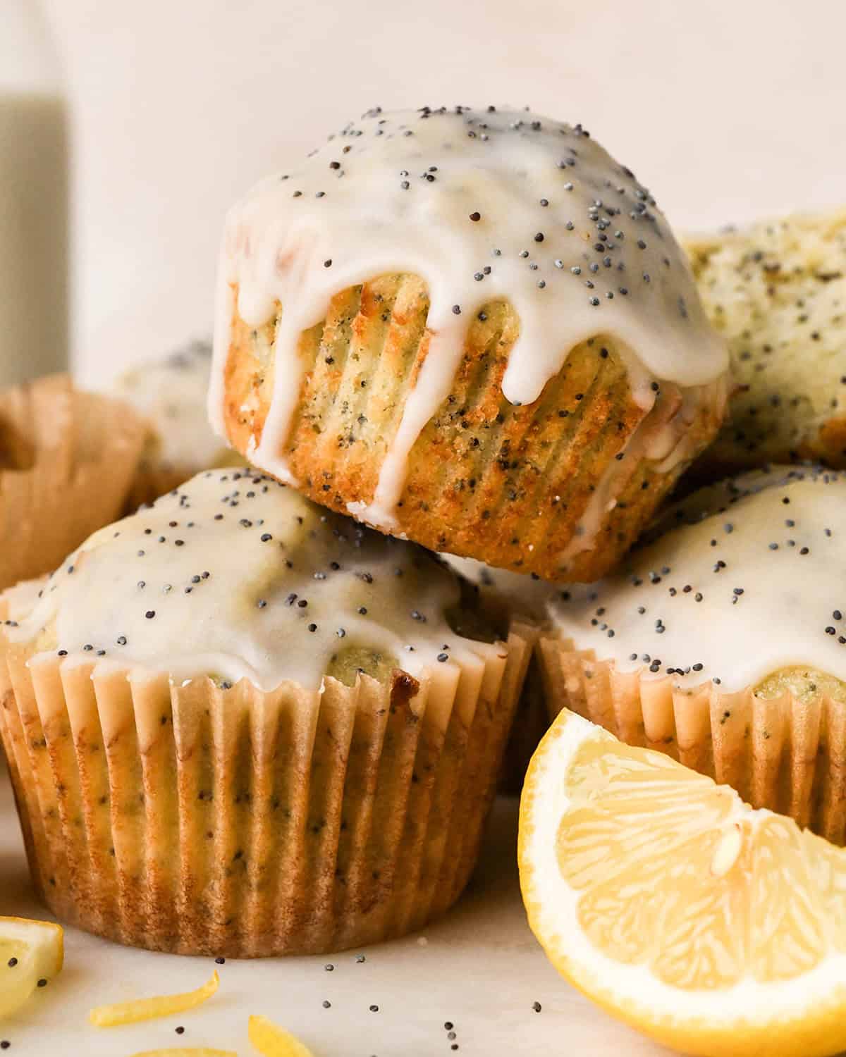 4 Lemon Poppy Seed Muffins, one stacked on the other 3 muffins, with glaze