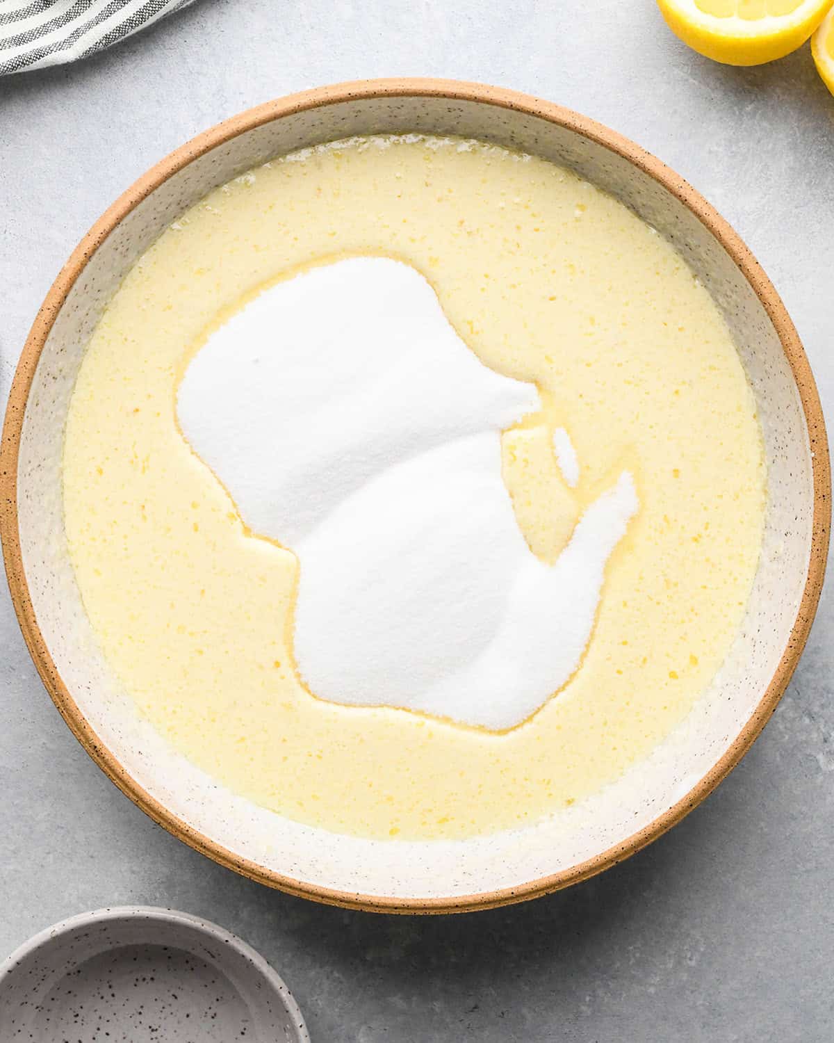 making Lemon Poppy Seed Muffins - sugar added to wet ingredients in a bowl before whisking