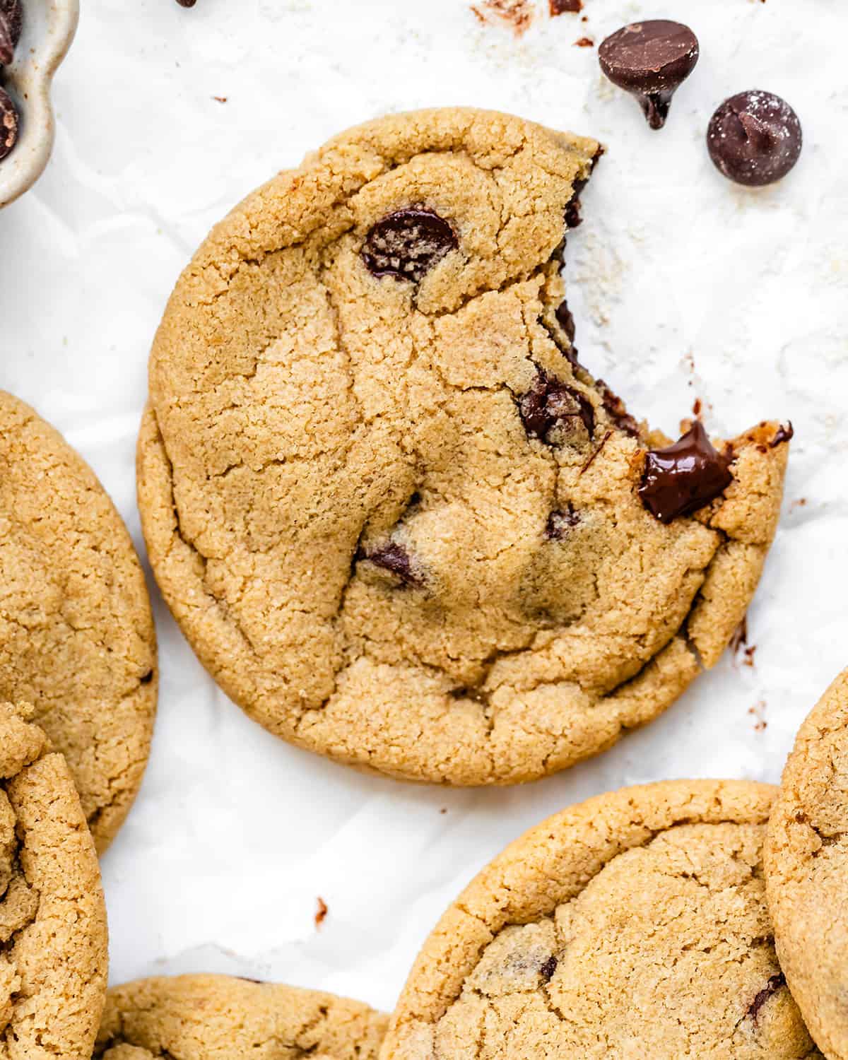 a Chocolate Chip Oat Flour Cookie with a bite taken out of it