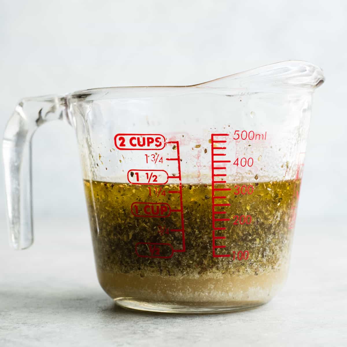 front view of a glass container with the homemade pasta salad dressing