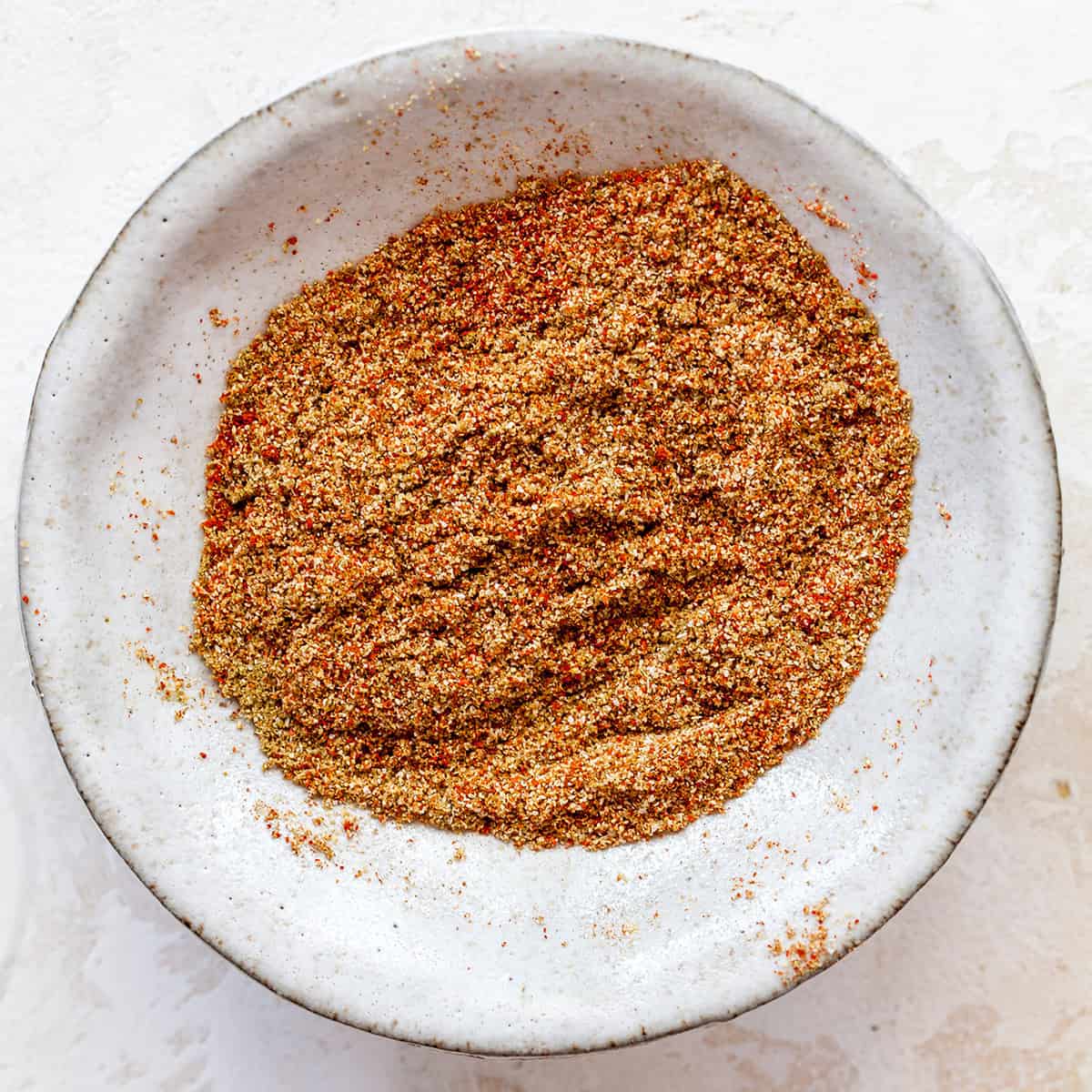 These healthy black bean sweet potato tacos are the best vegetarian tacos ever. Sweet potatoes and vegetables are perfectly spiced and roasted, then tossed with a honey, lime cilantro mixture for the most flavorful and delicious tacos. Taco night isn't complete without this sweet potato taco recipe! overhead view of the spice mixture in this sweet potato tacos recipe